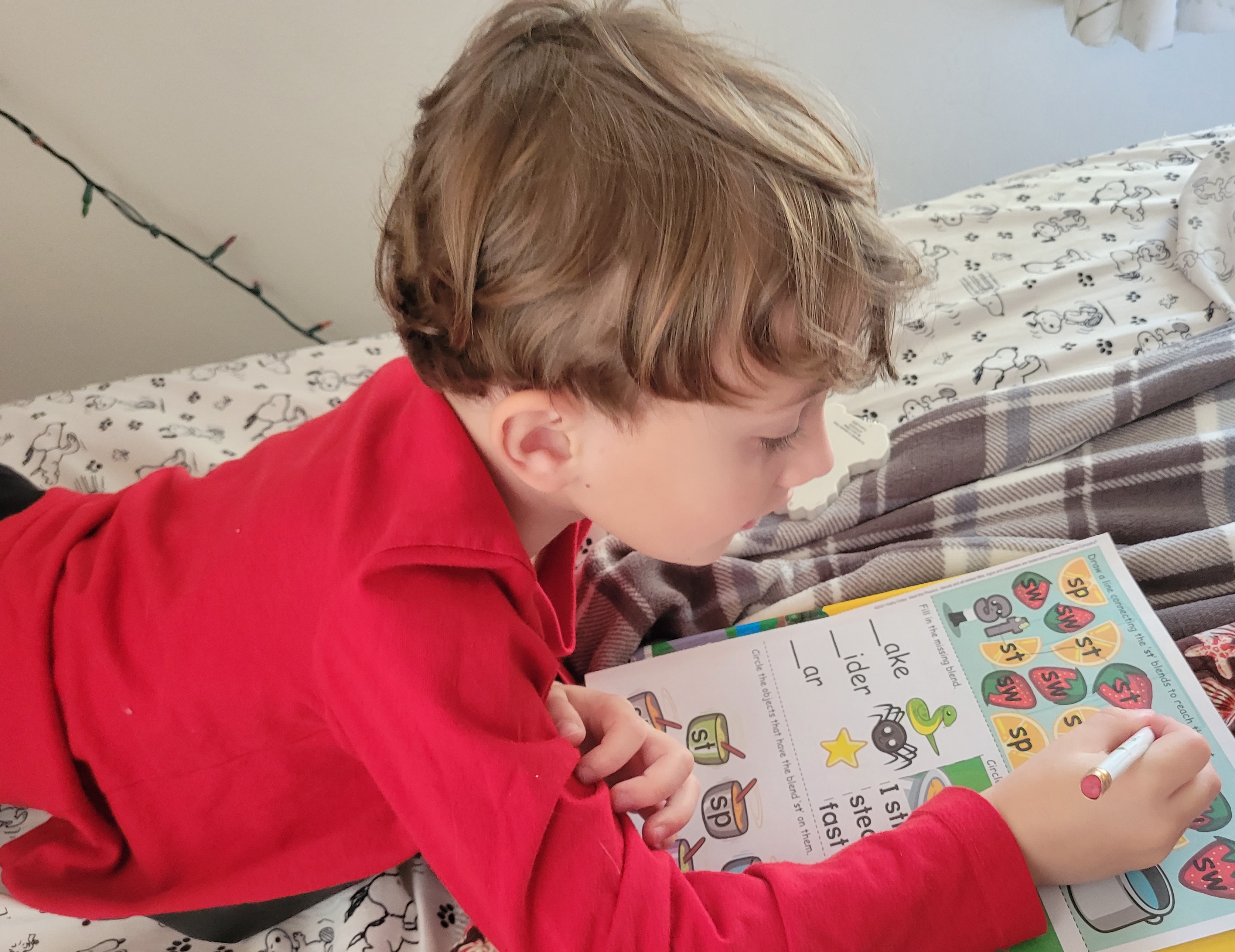 Kindergarten student doing his workbook