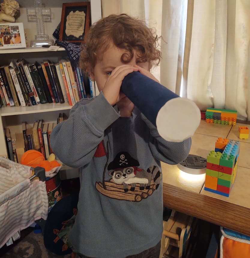 boy looking through telescope craft