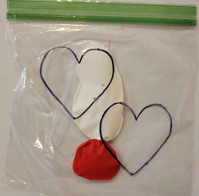 Red and white paint in a bag